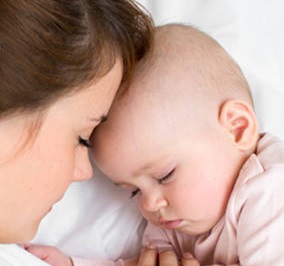 Young mother and her baby sleeping together